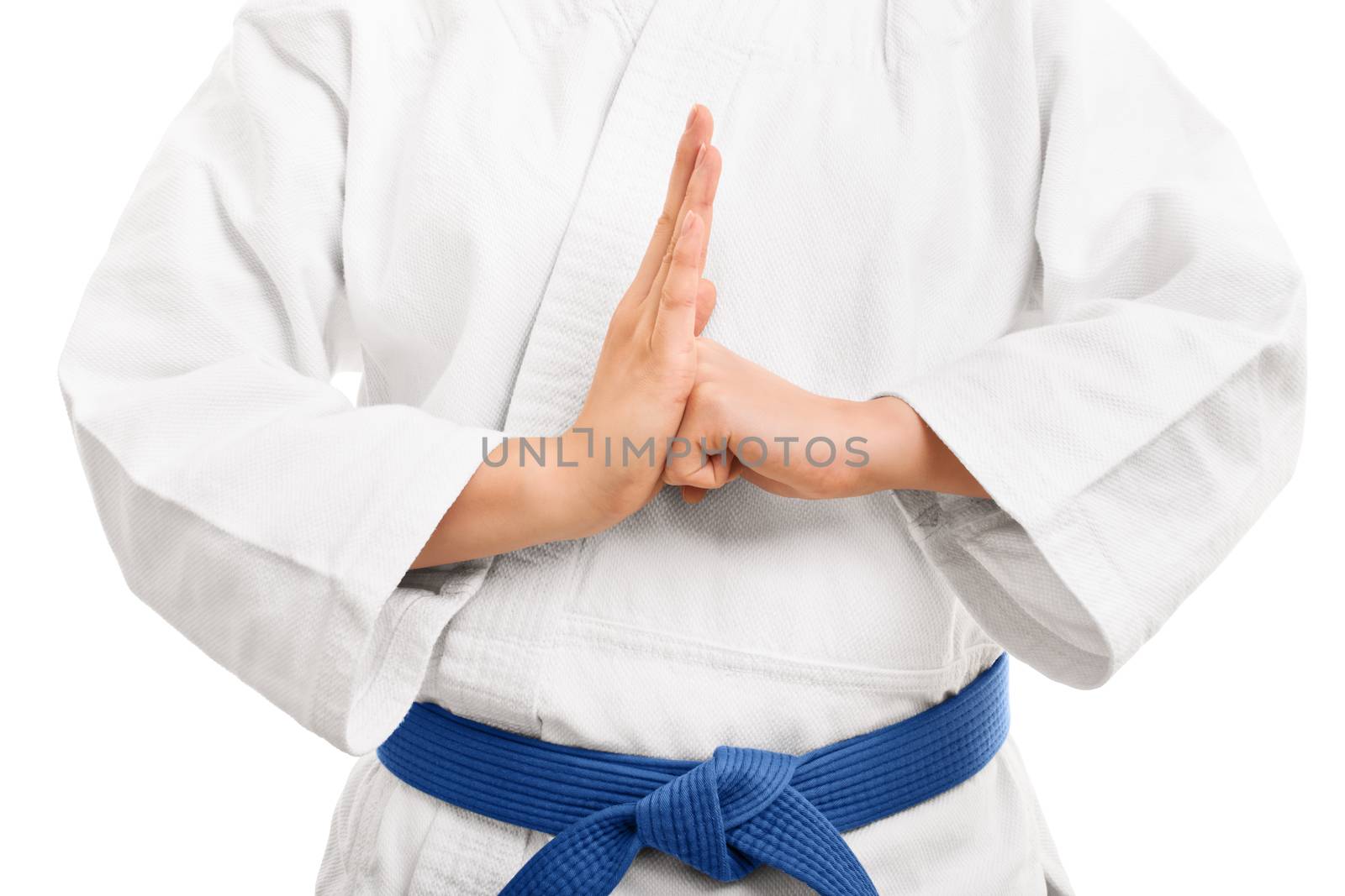 A close up shot of a martial arts fighter in a white kimono with blue belt performing a hand salute, isolated on white background.