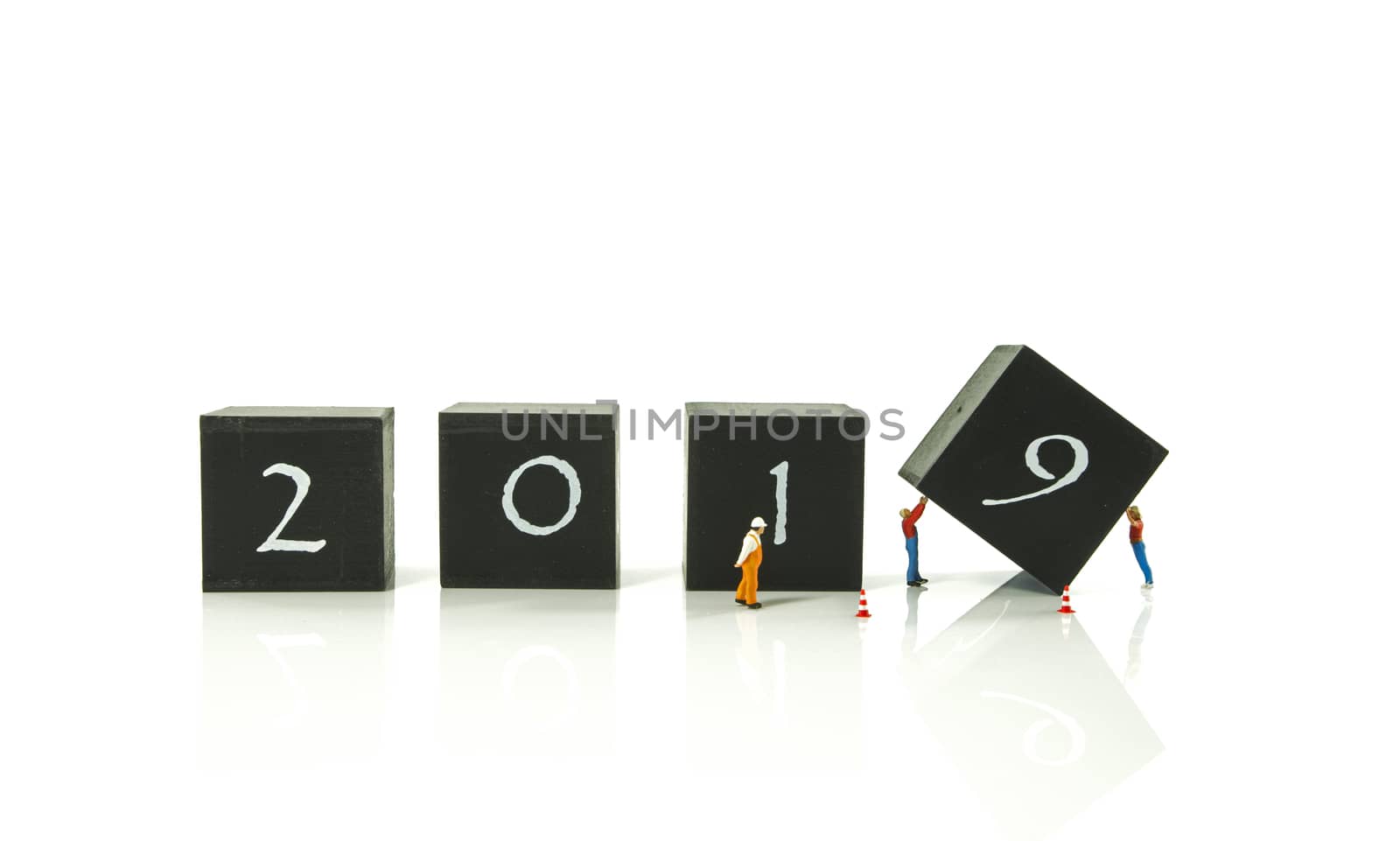 little world miniature figures busy with the turnaround from 2018 to 2019 isolated on white