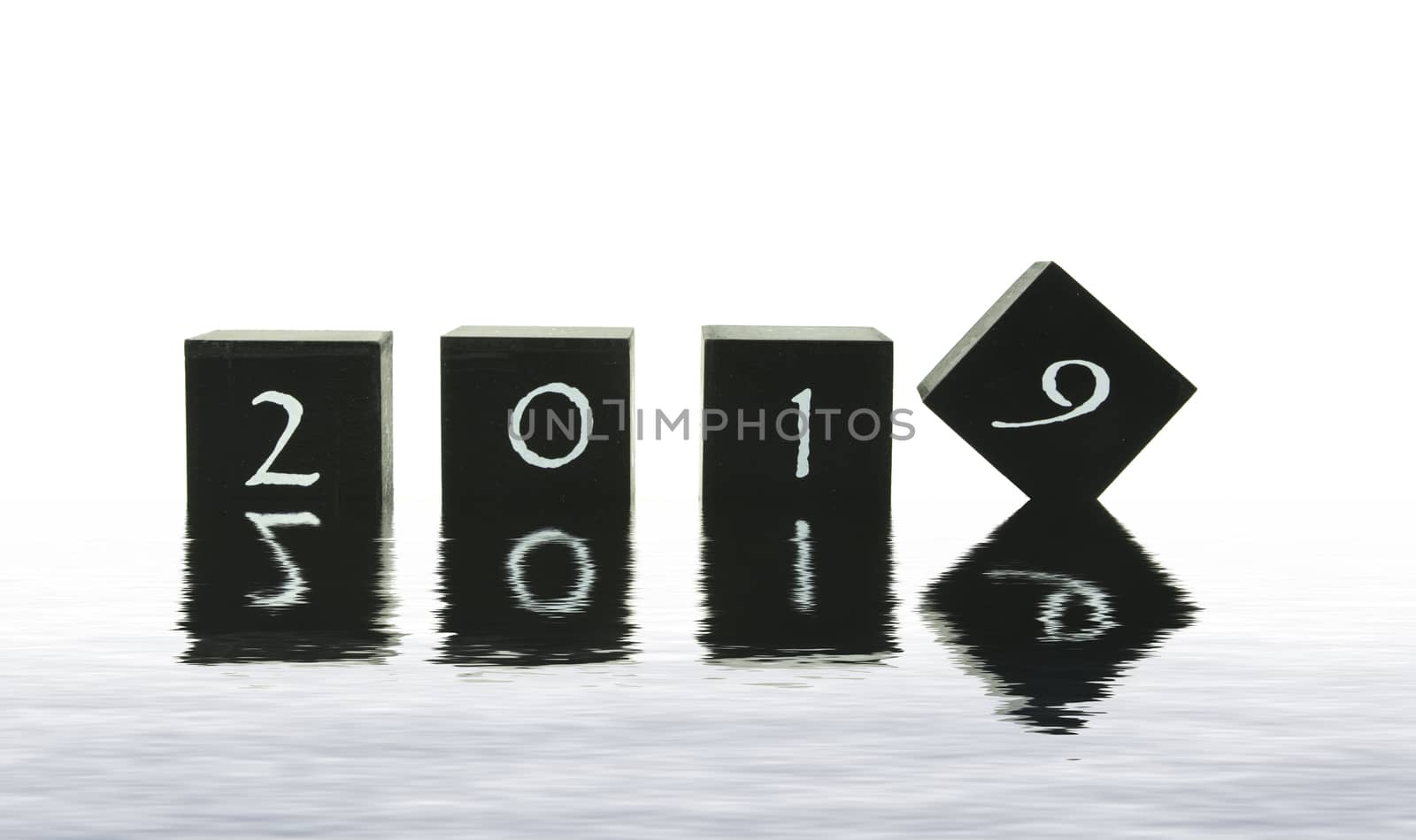 black blocks with 2018 changing in 2019 isolated on white in water reflection