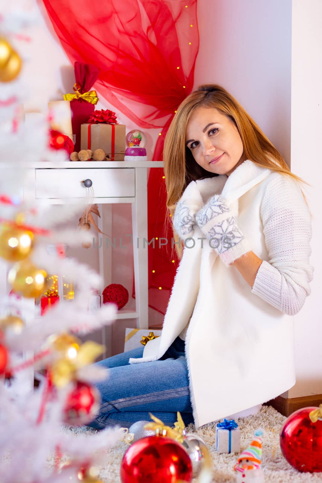 Girl in warm flea clothes in the New Year's interior