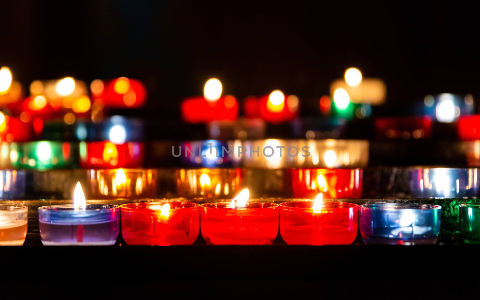 Colorful prayer candles in catholic church