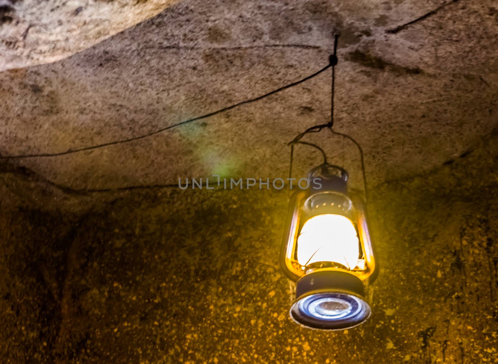 retro lantern hanging on the roof of a cave, Nostalgic mining equipment by charlottebleijenberg
