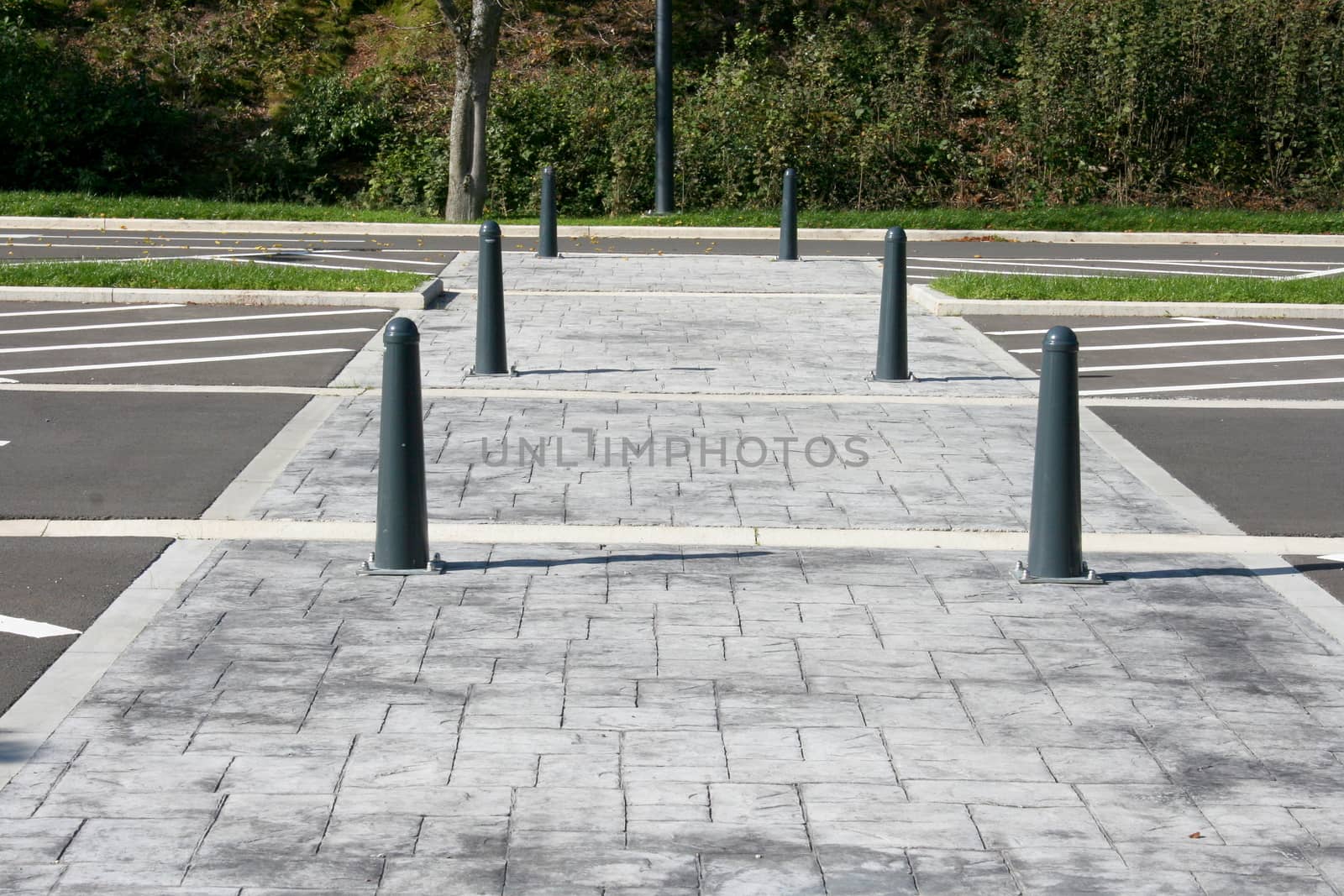 Limited gray paved walkway with iron posts