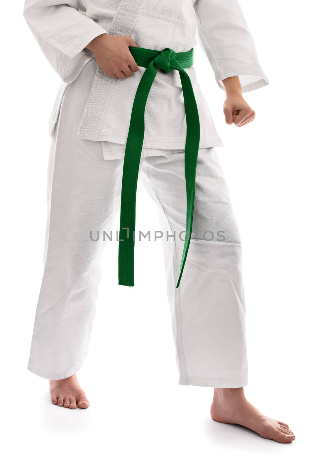 Below the waist shot of a martial arts fighter in white kimono with green belt in a combat stance, isolated on white background.