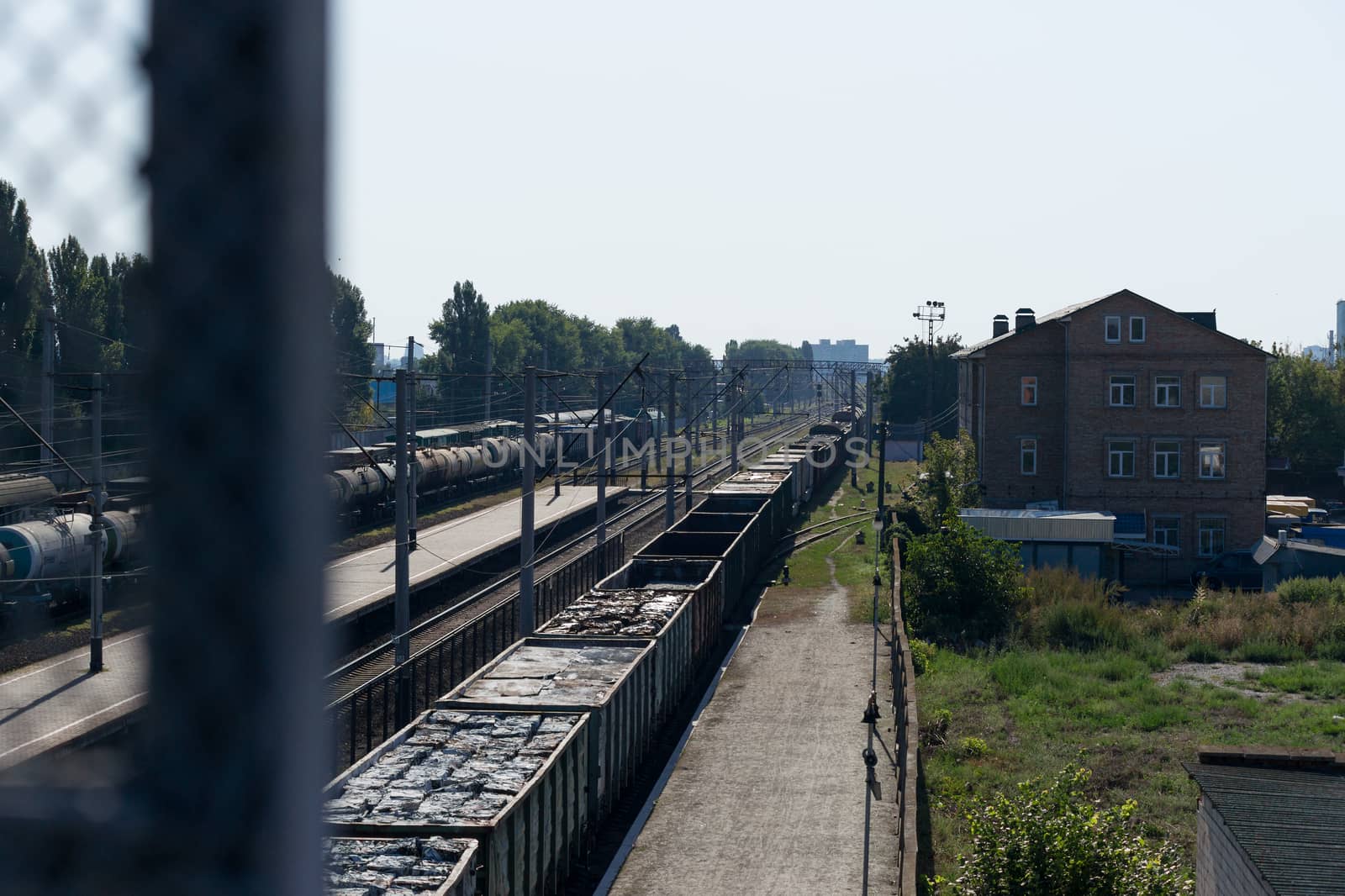 A train with freight cars full of garbage packs. by alexsdriver