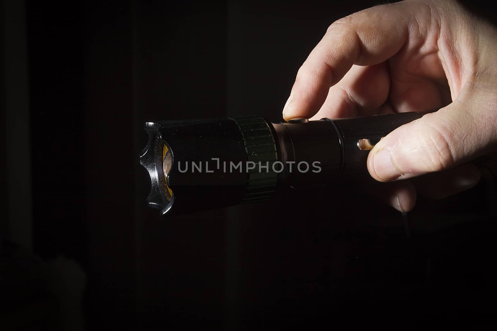 Hand holds flashlight by VIPDesignUSA