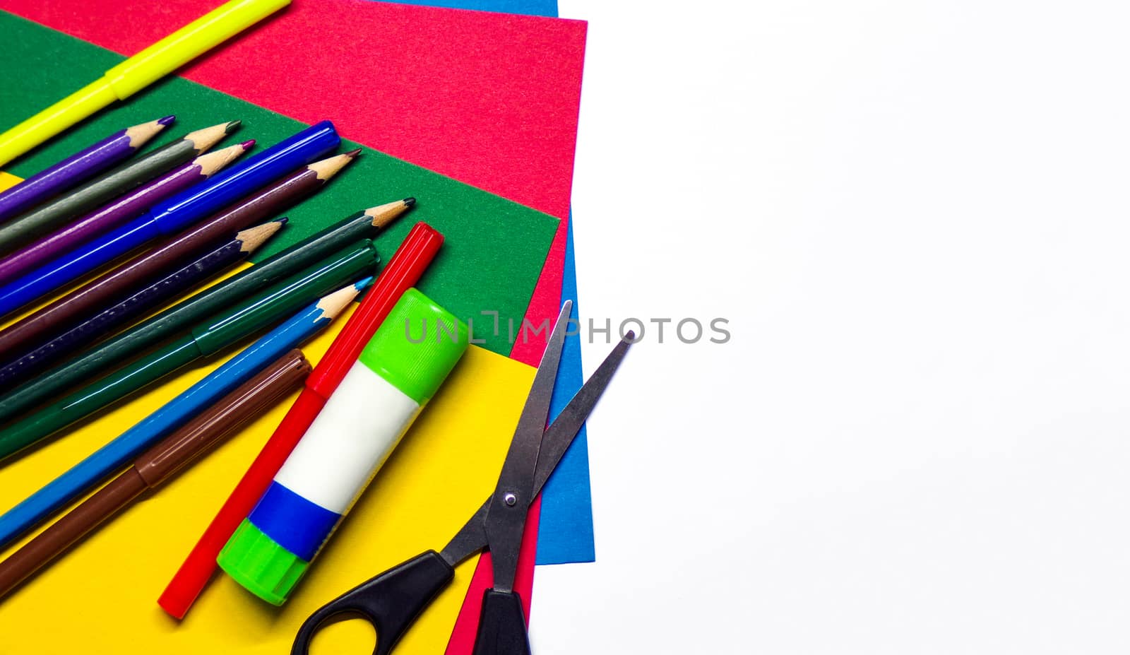 School stationery and supplies on a white background. Creative school background with copy space. Pencils. Felt pen. Glue. Scissors. Colored cardboard. Origami. crafts with your own hands.