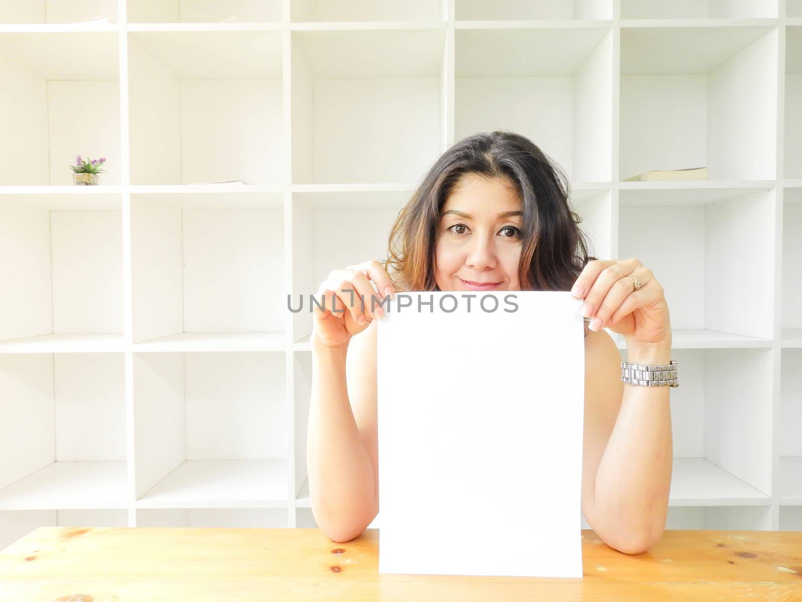 Attractive beautiful woman holding blank white paper. by yuiyuize