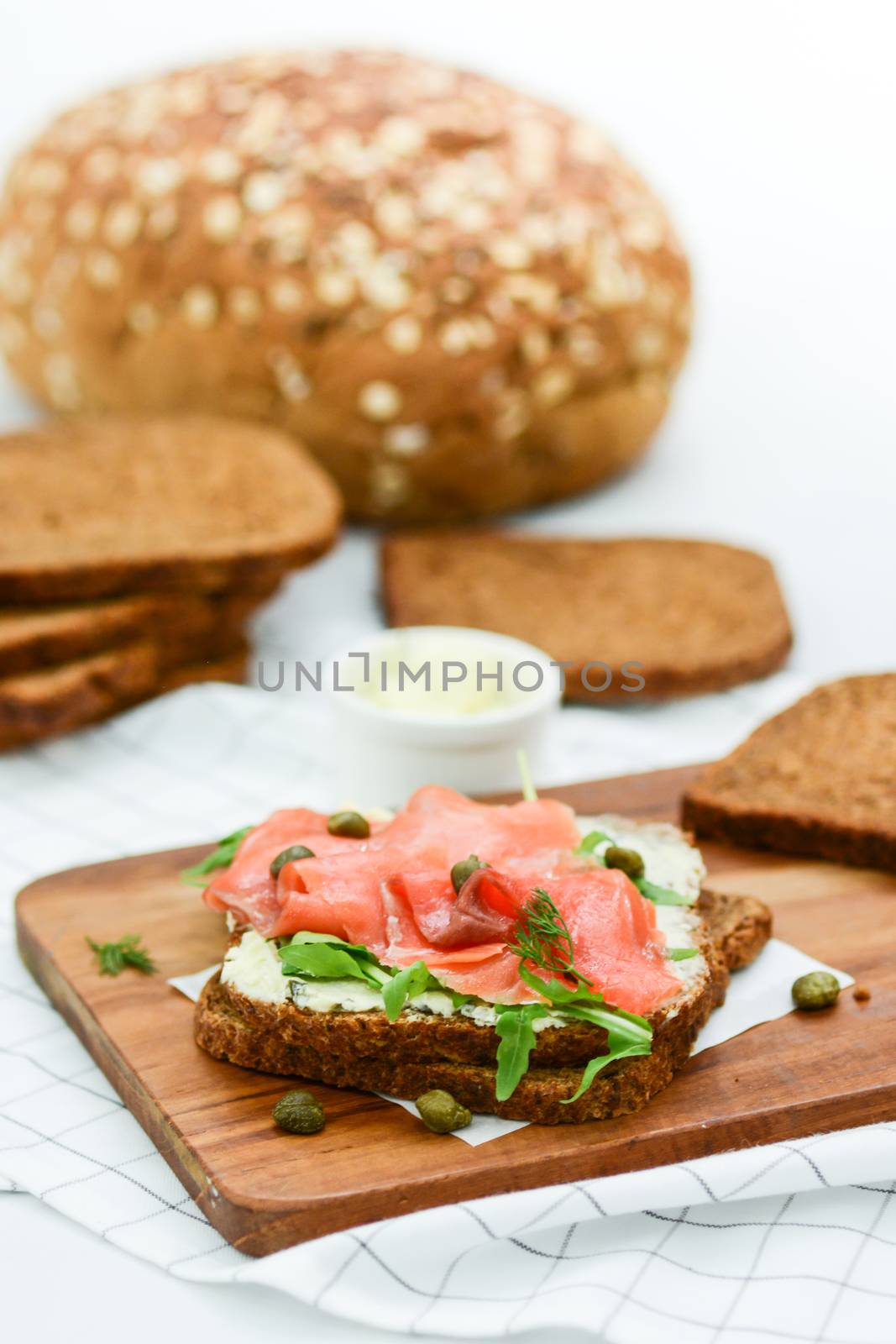 Smoked salmon sandwich with cheese, pistachio and salad leaves,  by yuiyuize