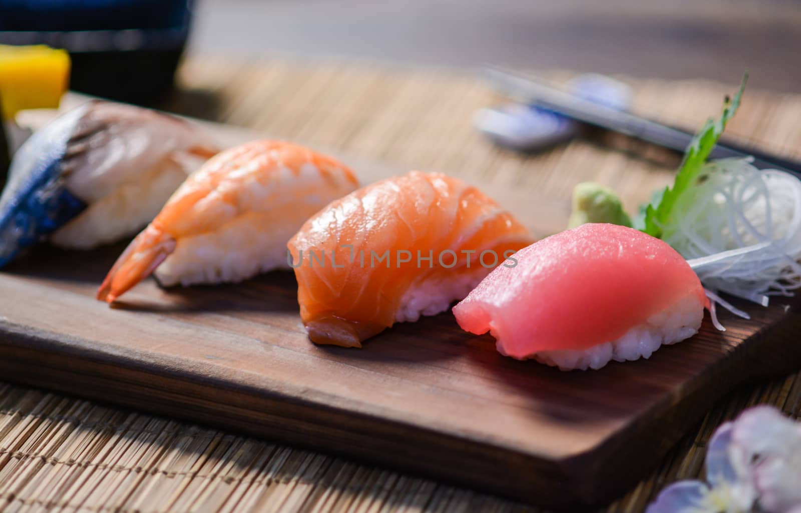 Mix sushi on wood dish, tuna, salmon, sea bass, sweet egg, shrimp sushi, Japanese food