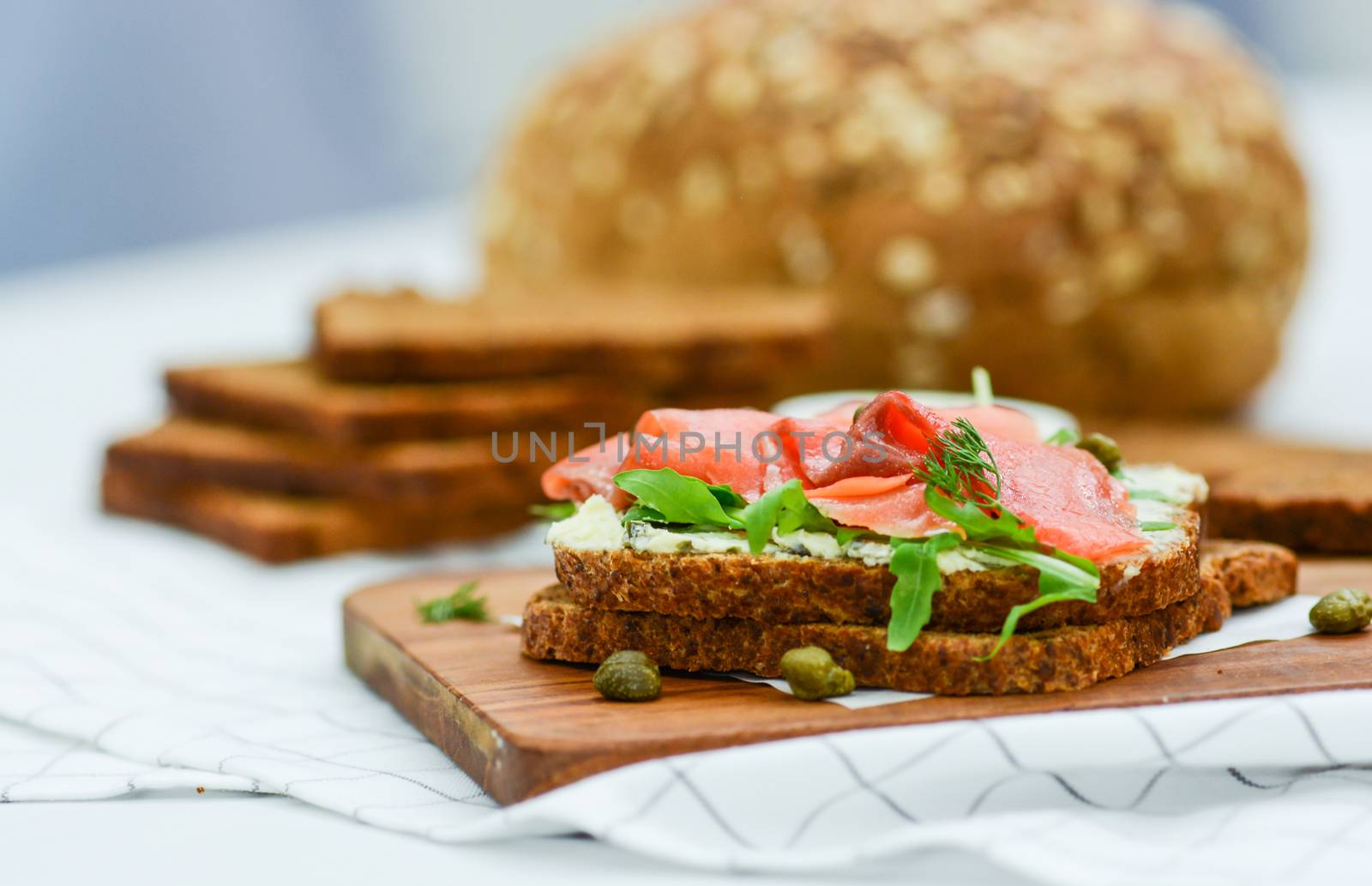 Smoked salmon sandwich with cheese, pistachio and salad leaves,  by yuiyuize