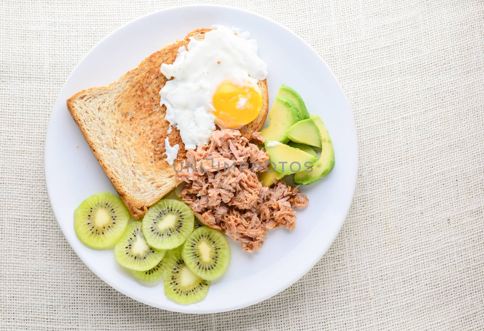 Modern style clean food, bread, egg, tuna salad, kiwi and avocad by yuiyuize