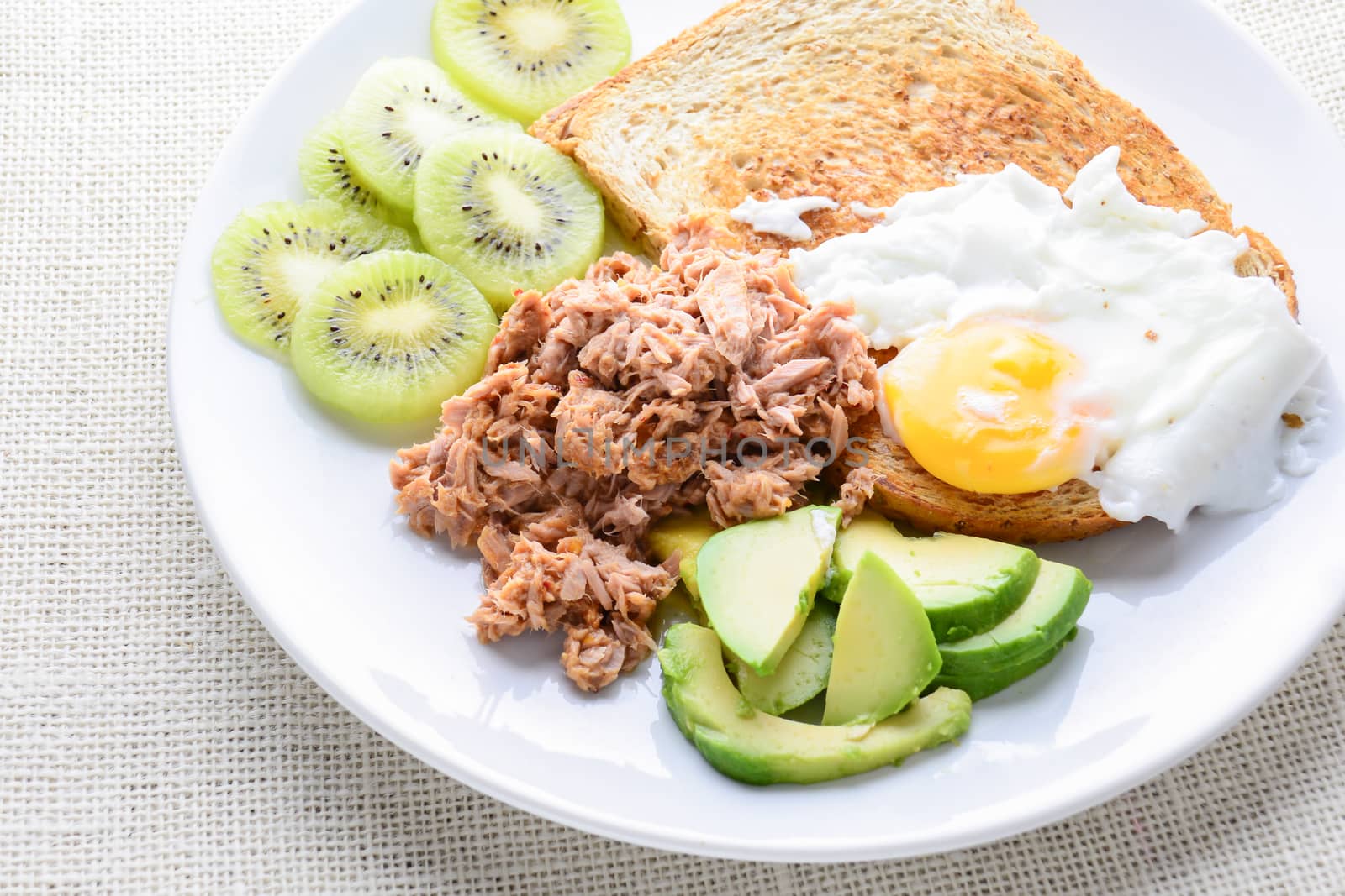 Modern style clean food, bread, egg, tuna salad, kiwi and avocad by yuiyuize