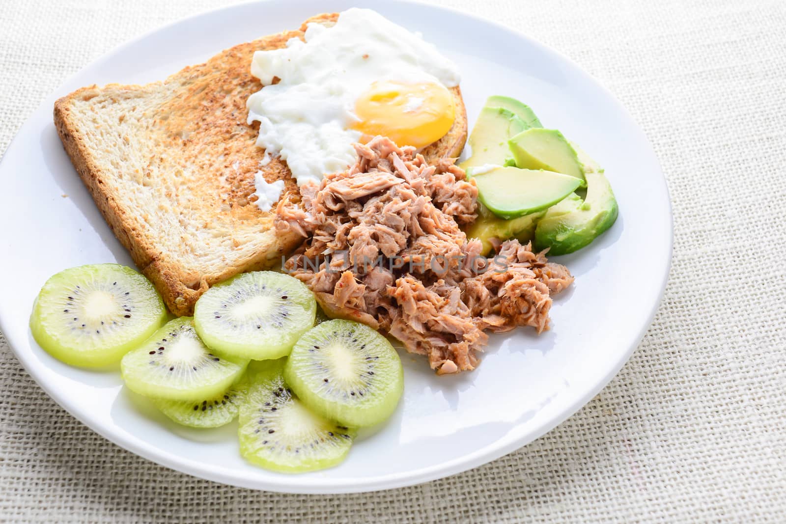 Modern style clean food, bread, egg, tuna salad, kiwi and avocado