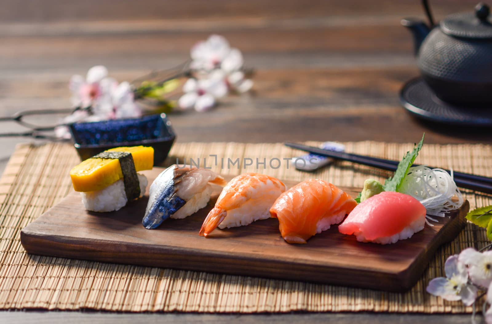 Mix sushi on wood dish, tuna, salmon, sea bass, sweet egg, shrimp sushi, Japanese food