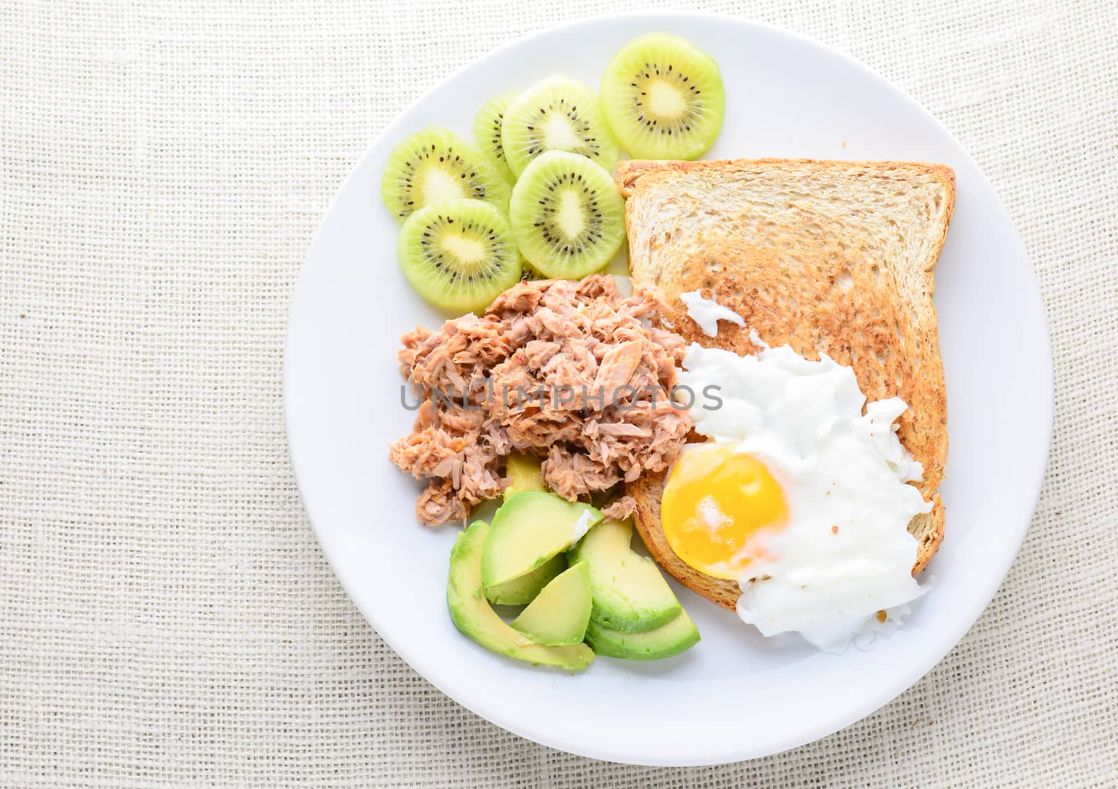 Modern style clean food, bread, egg, tuna salad, kiwi and avocad by yuiyuize