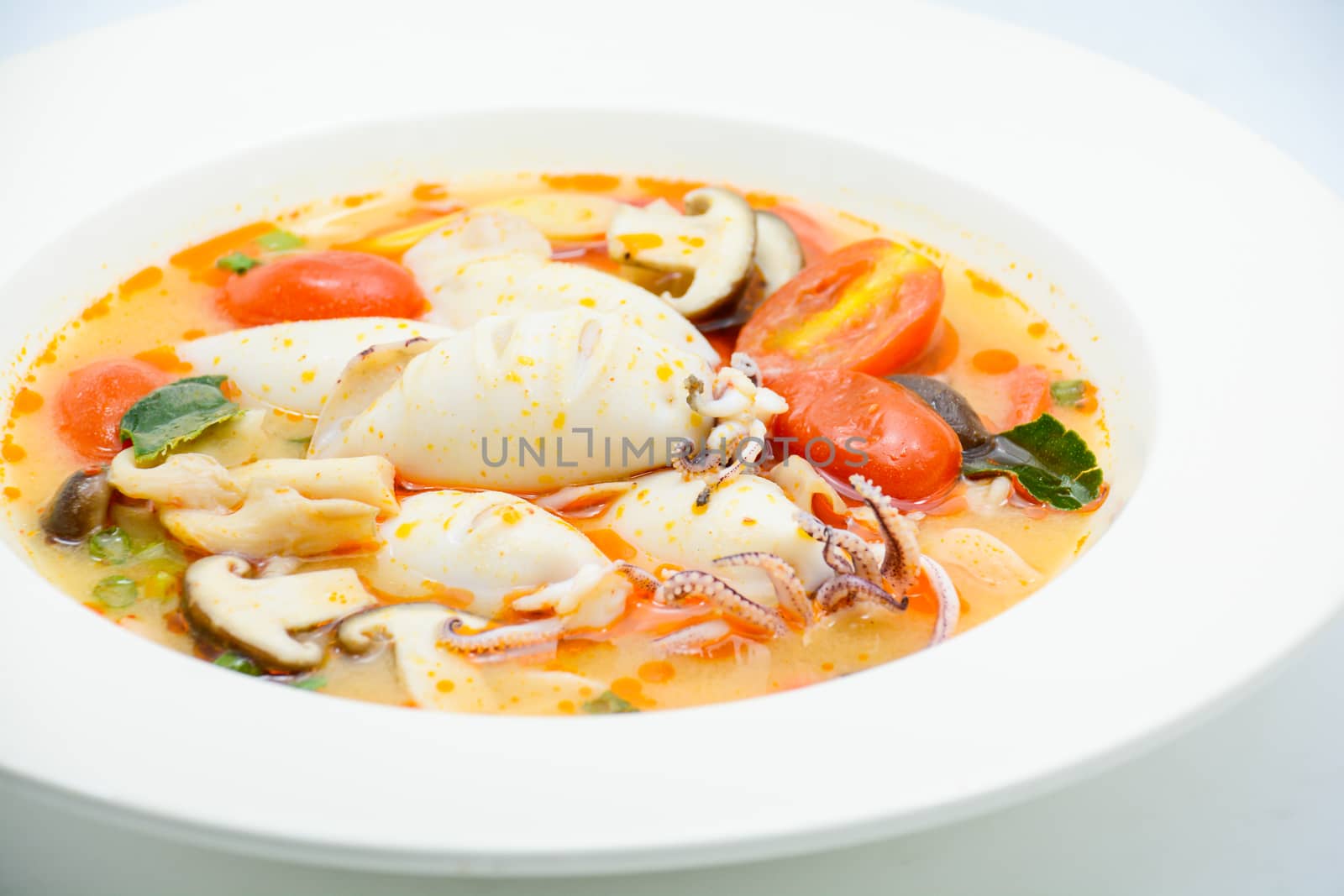 Squids and lemon grass spicy soup with mushrooms, tomatoes and h by yuiyuize