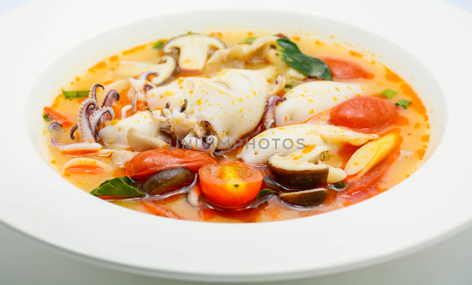 Squids and lemon grass spicy soup with mushrooms, tomatoes and h by yuiyuize