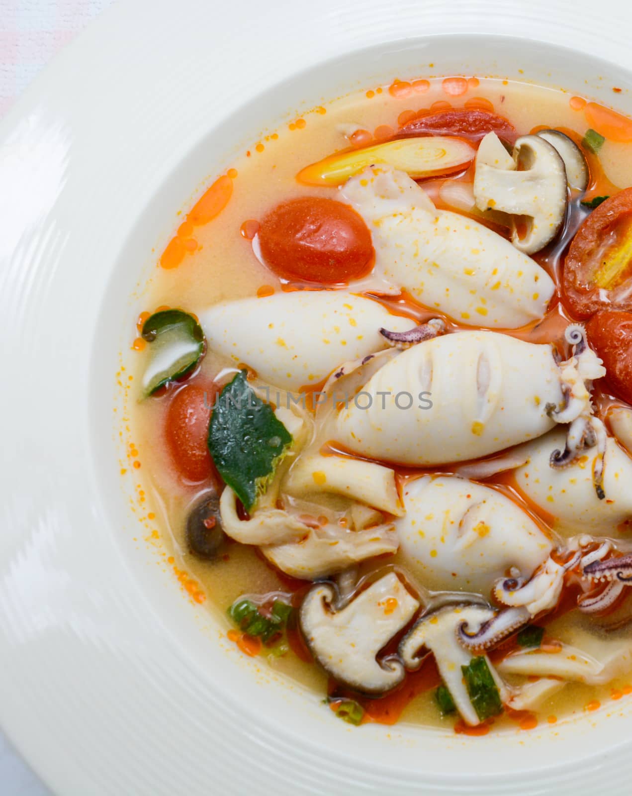 Squids and lemon grass spicy soup with mushrooms, tomatoes and h by yuiyuize