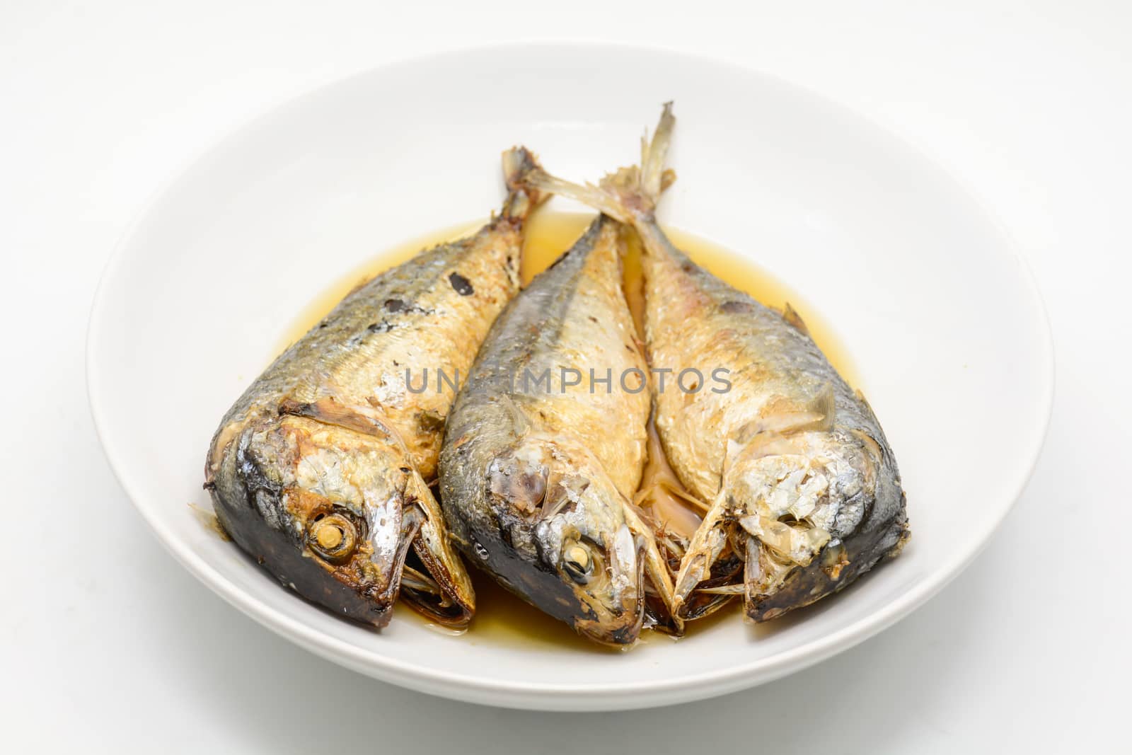 Fried mackerel on white plate. Deep fried fish by yuiyuize