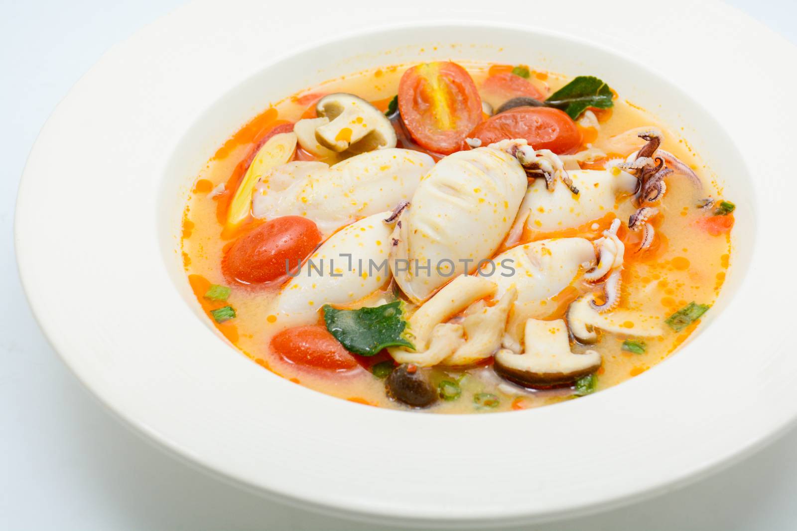 Squids and lemon grass spicy soup with mushrooms, tomatoes and h by yuiyuize