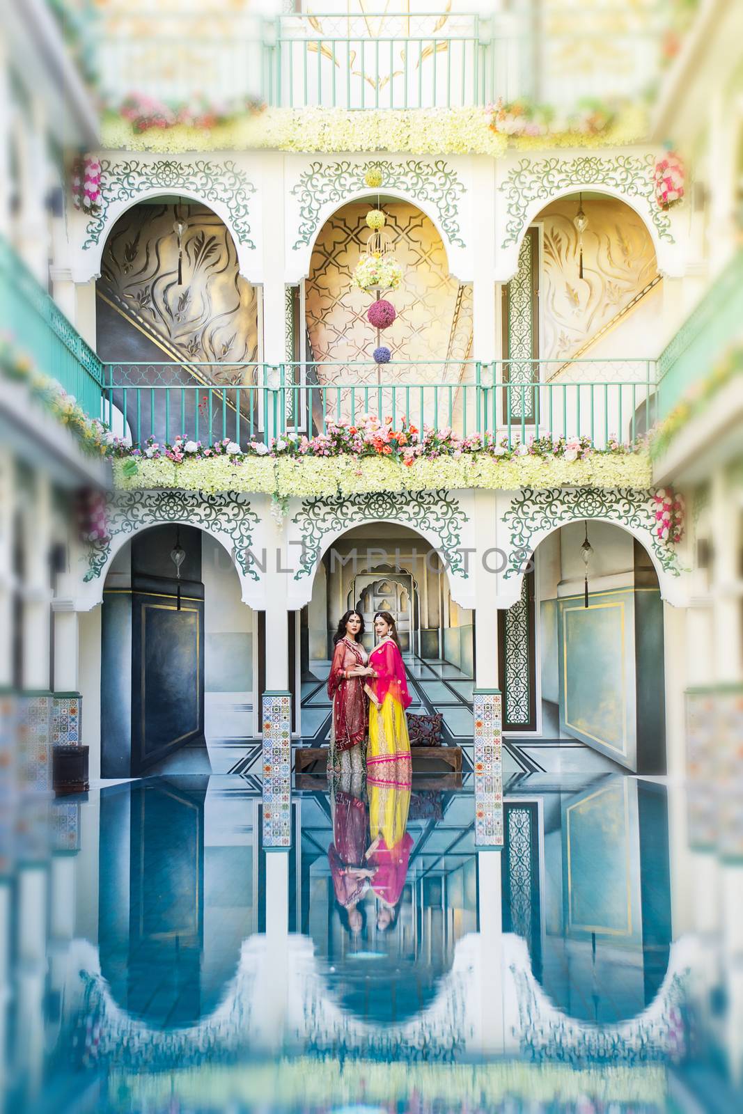 Pink and Yellow Indian Costume Beautiful Girl, face partially covered with saree. Portrait of Traditional woman in sari dress.
