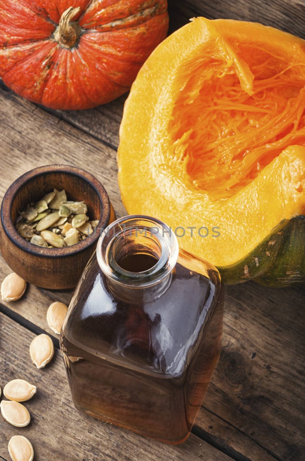 Pumpkin and pumpkin seed oil on wooden table