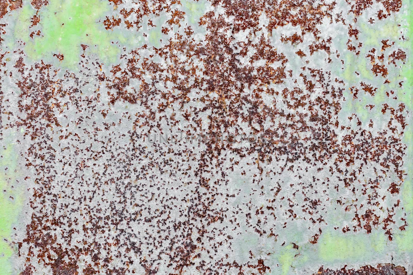 background texture pattern of old rusty iron wall with green paint close up