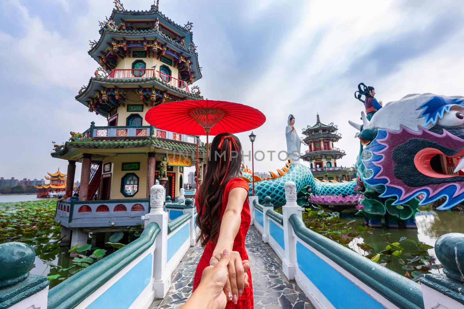 Women tourists holding man's hand and leading him to Kaohsiung's famous tourist attractions in Taiwan. by gutarphotoghaphy