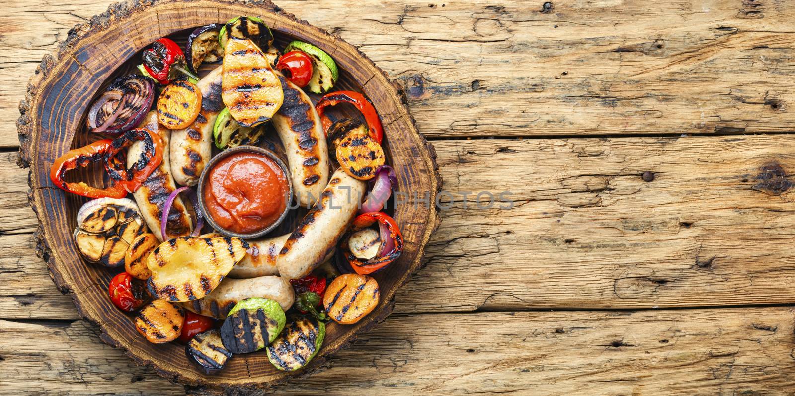 Grilled sausages fried with pear and vegetables. Autumn food.