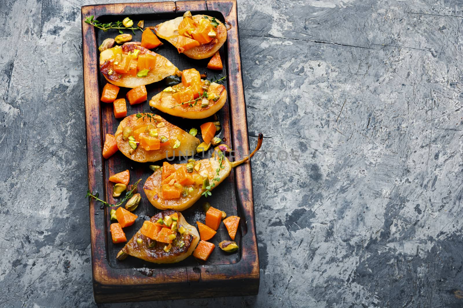 Stuffed pear pumpkin and pistachio.Baked pear.Autumn food.