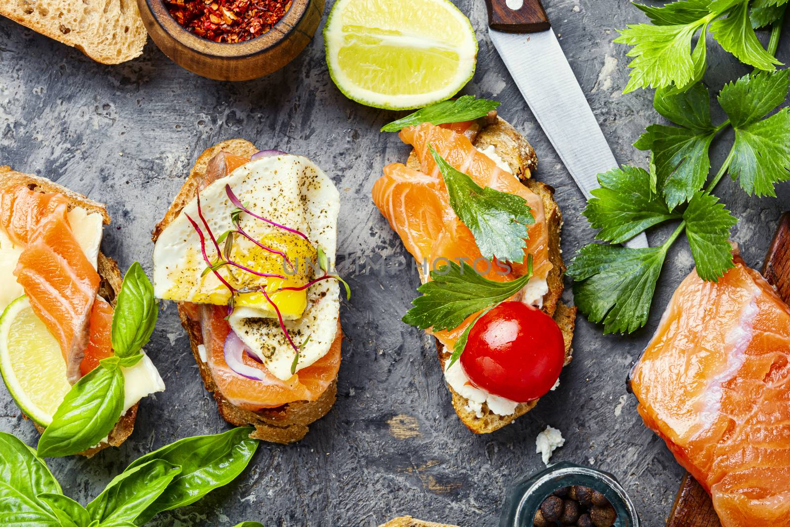 Open sandwich with salmon and vegetables.Small sandwiches.Toasts with salted salmon