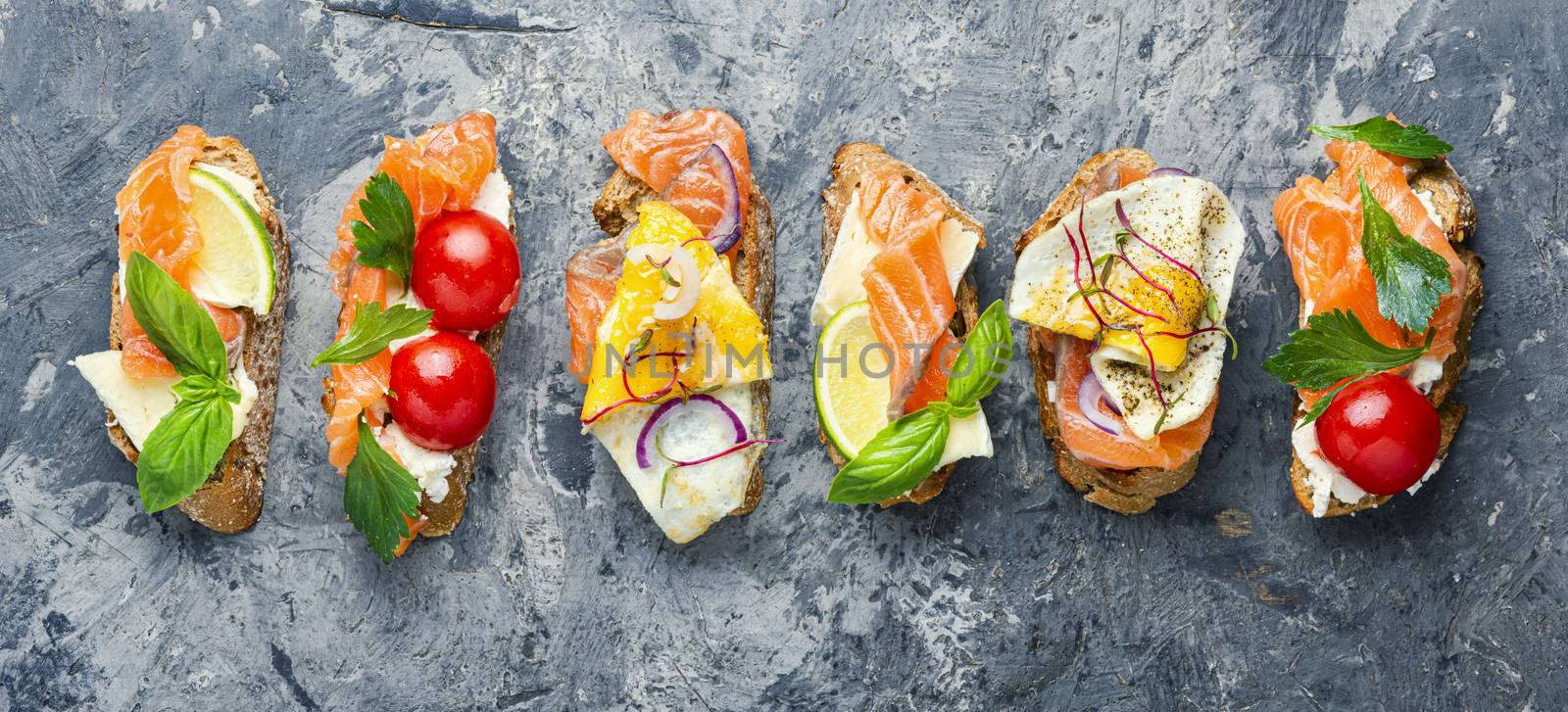 Traditional italian bruschetta.Open sandwich with salmon and vegetables