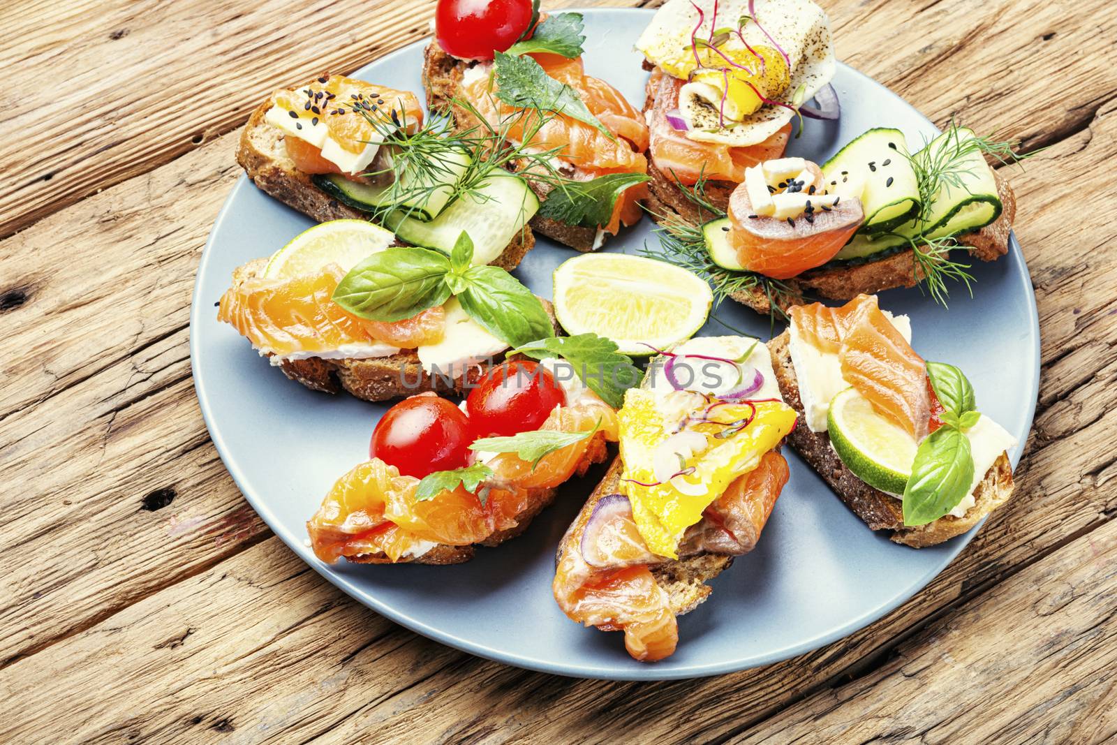 Traditional italian bruschetta.Open sandwich with salmon and vegetables