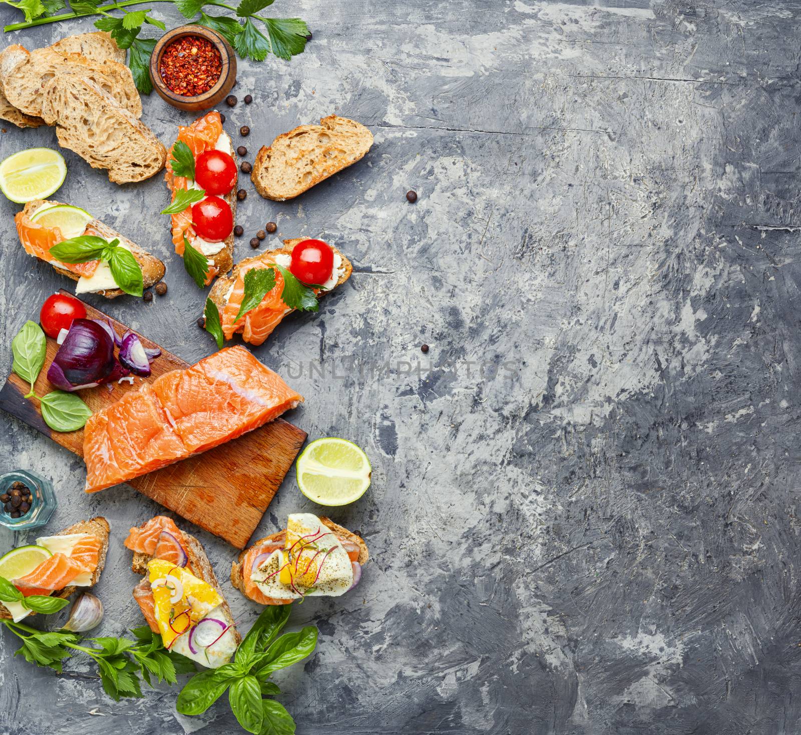 Traditional italian bruschetta.Open sandwich with salmon and ingredients