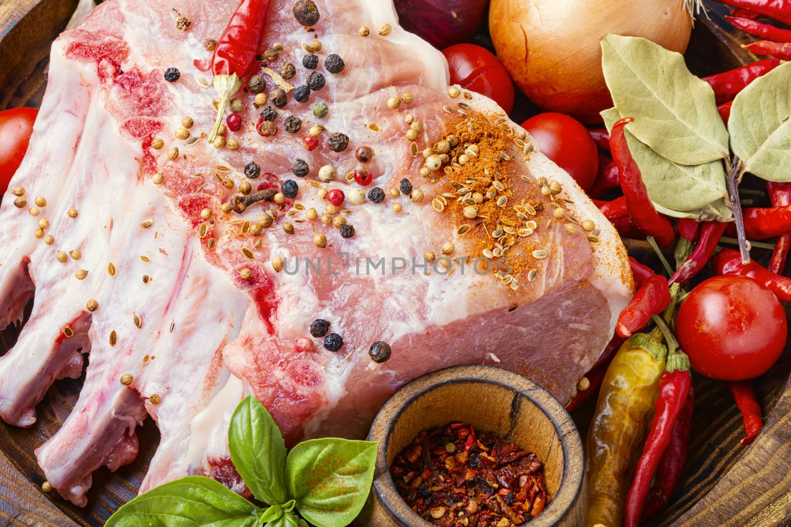 Ribs and pork chops uncooked.Fresh,raw meat and spices