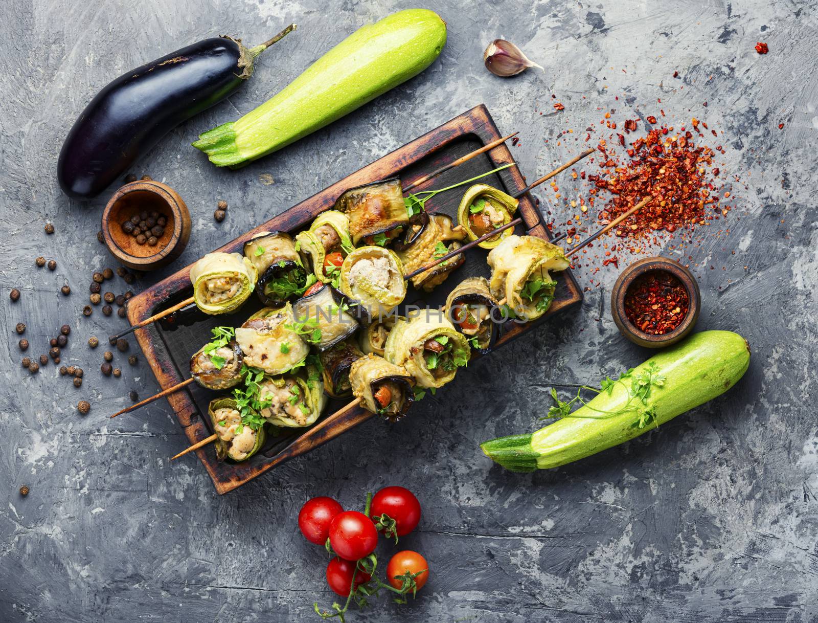 Eggplant and zucchini stuffed with meat on skewers.Flat lay with copy space