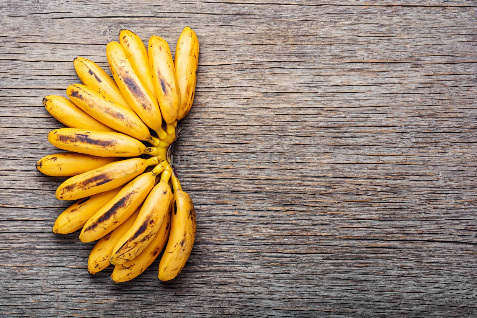 Bananas on an old wooden table.A bunch of ripe bananas.