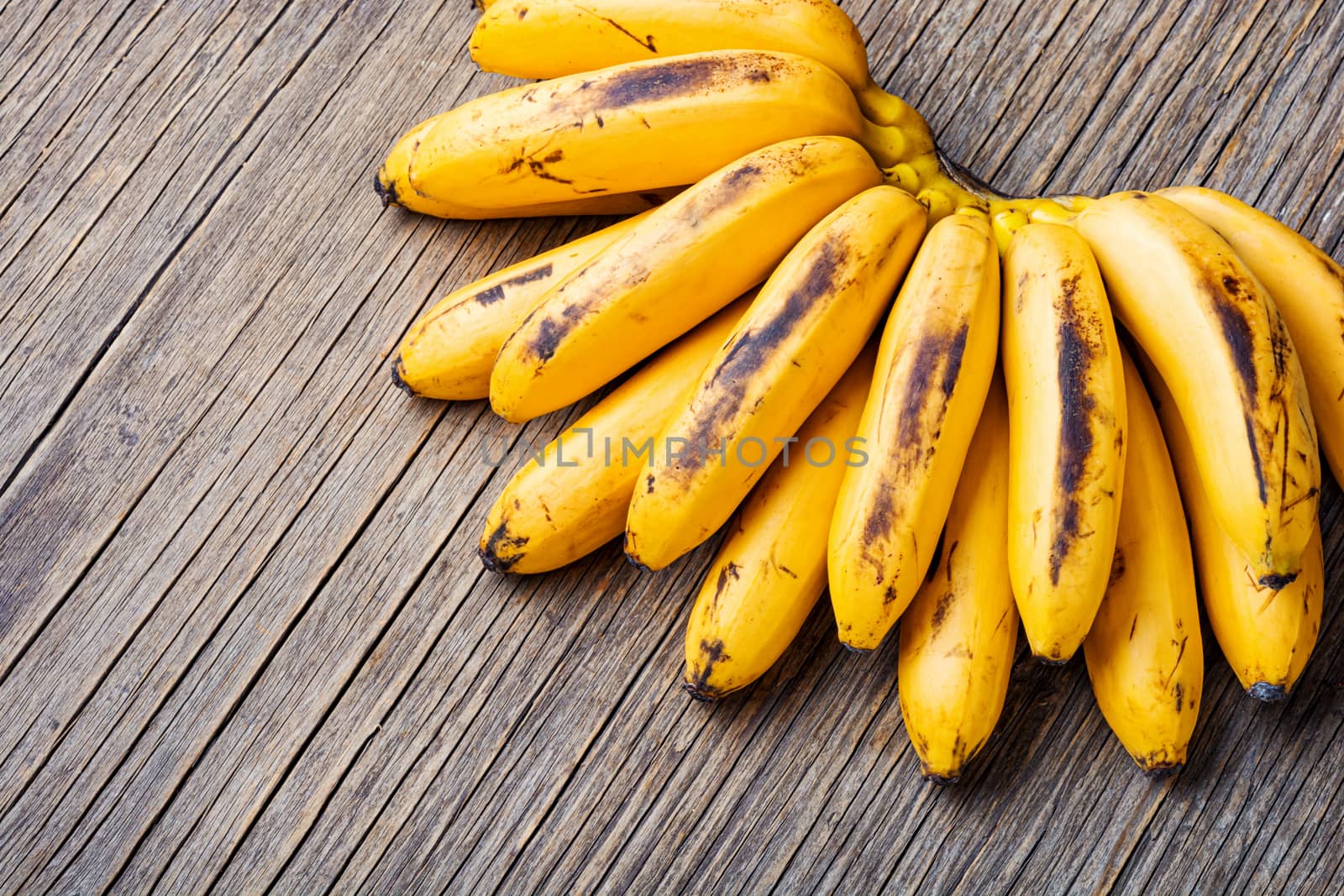 Bananas on an old wooden table.A bunch of ripe bananas.