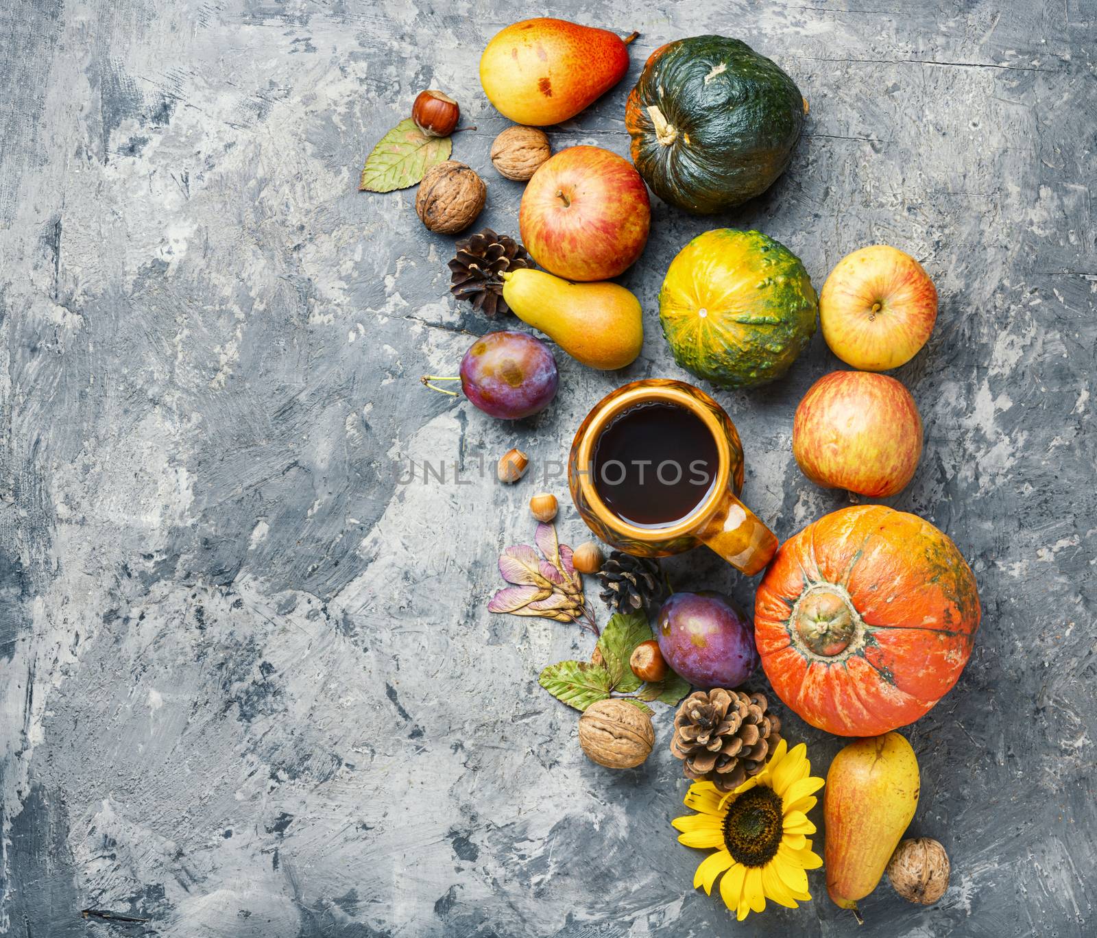 Autumn composing with pumpkin, fruit and fall leaves.Fall season