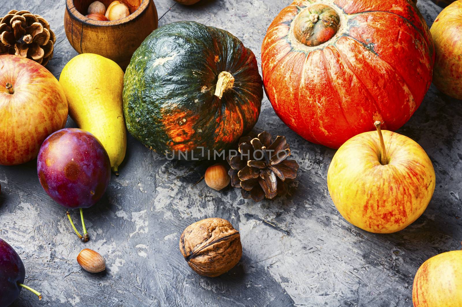 Autumn composing with pumpkin, fruit and fall leaves