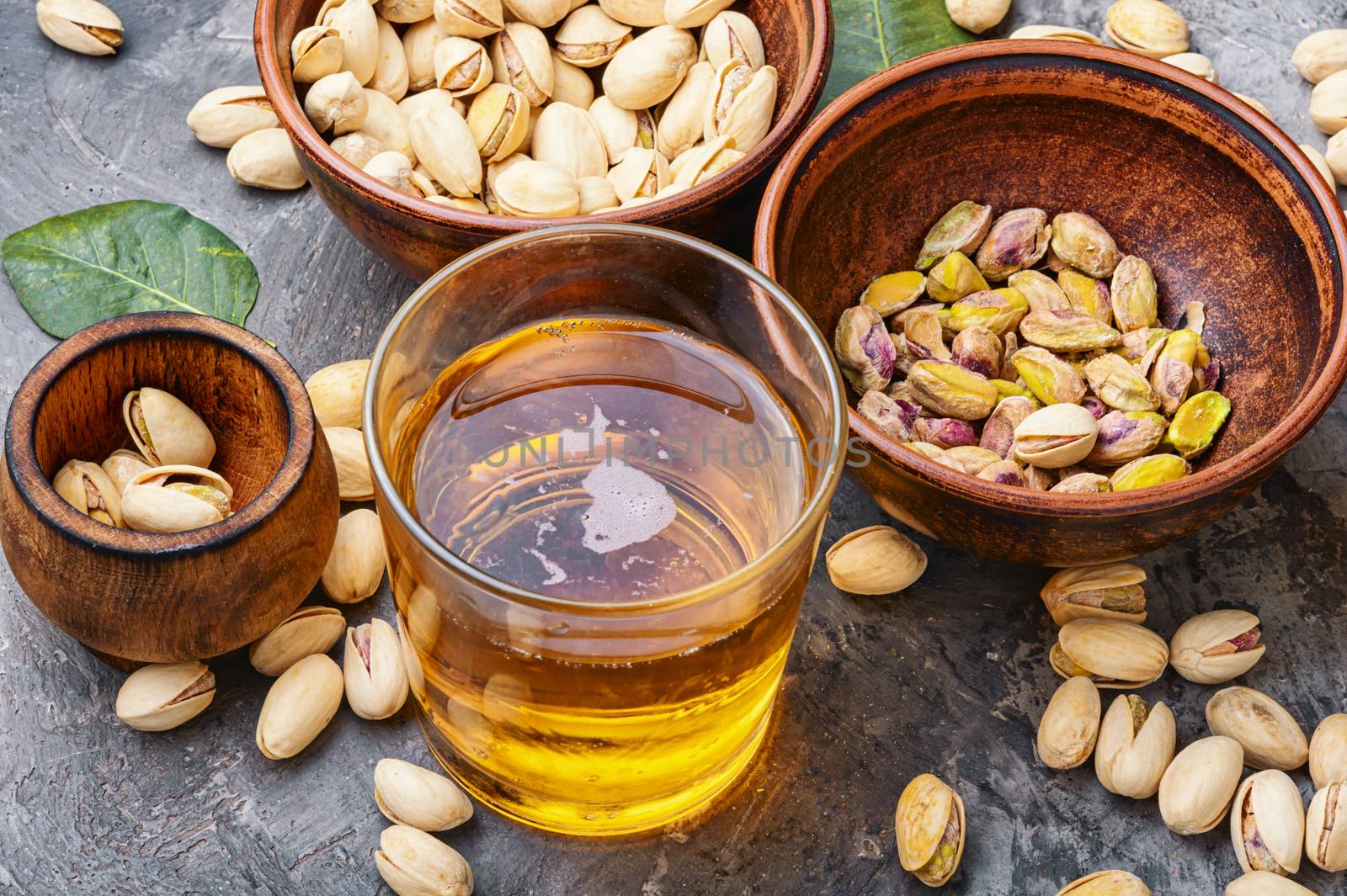 Pistachio nuts in a bowl by LMykola