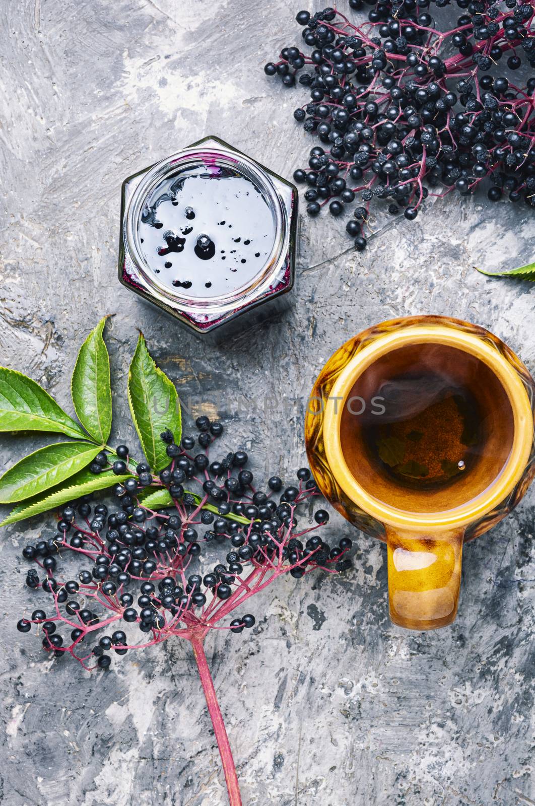 Elderberry jam and fresh berries.Homemade jam and a cup of tea