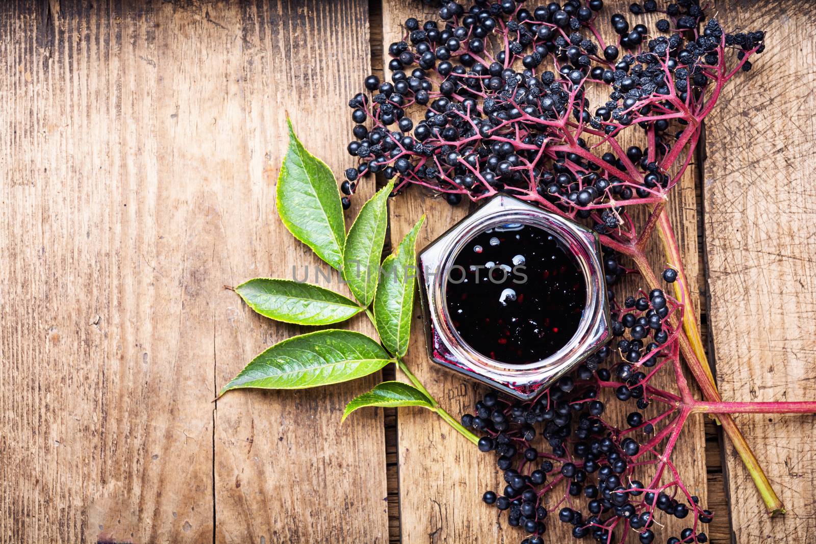 Elderberry jam and fresh berries.Homemade jam.Space for text