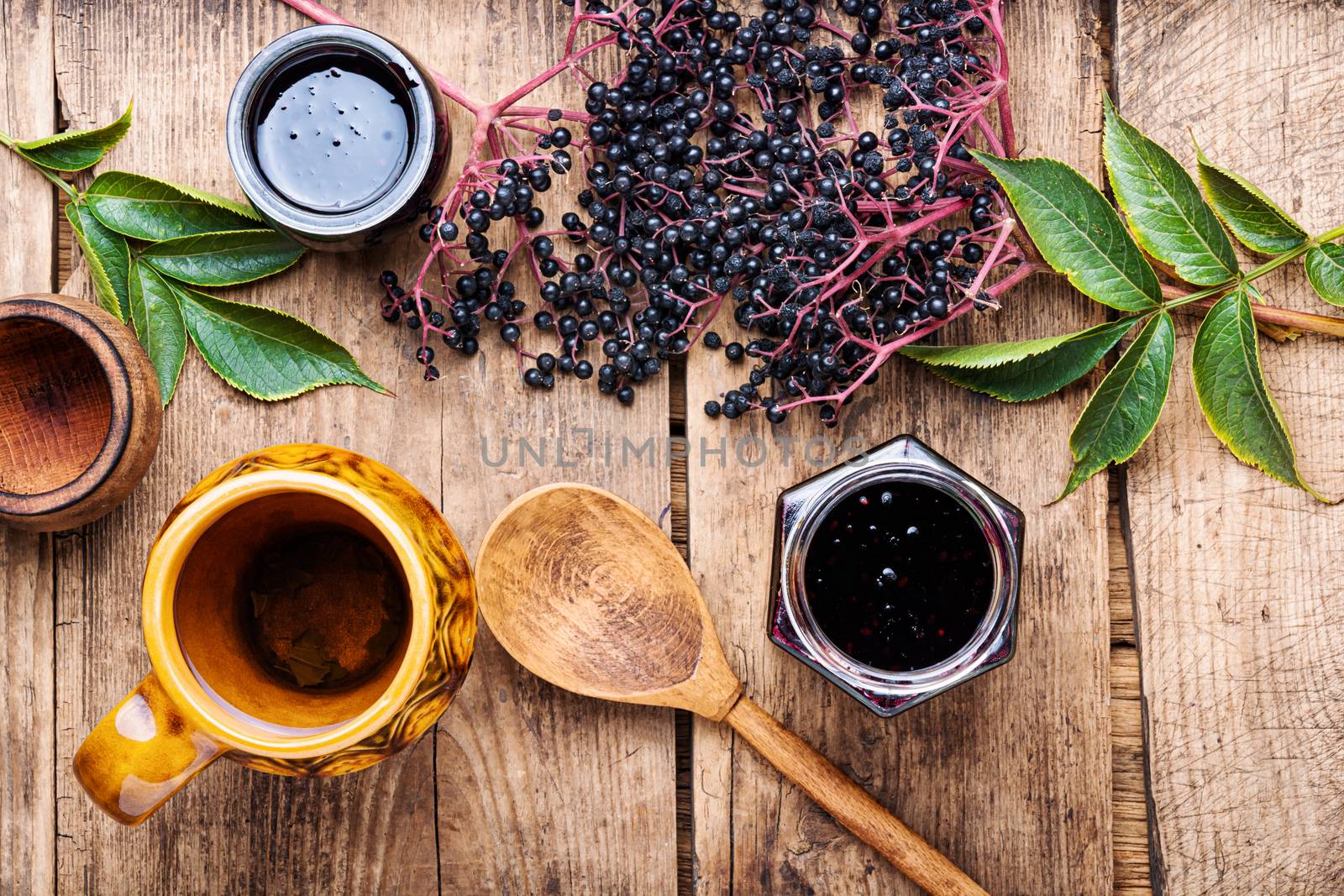 Elderberry jam and fresh berries.Homemade jam on retro wooden background