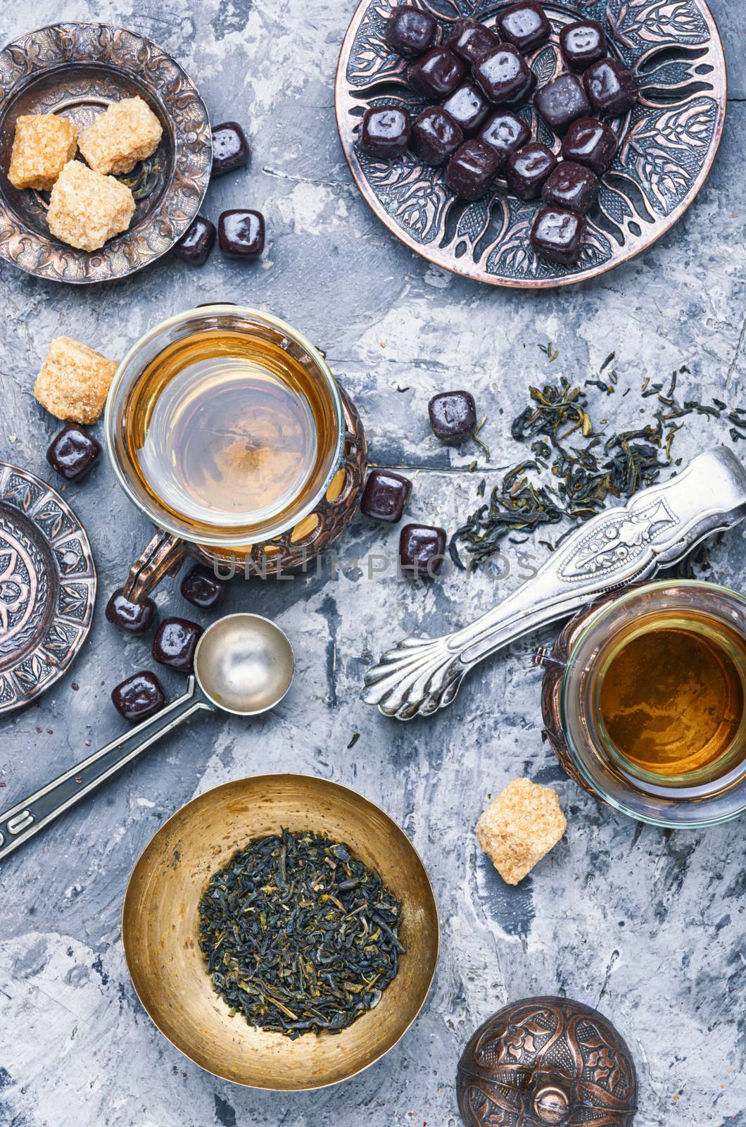 Eastern tea in traditional glass with chocolate.Two turkish tea cups