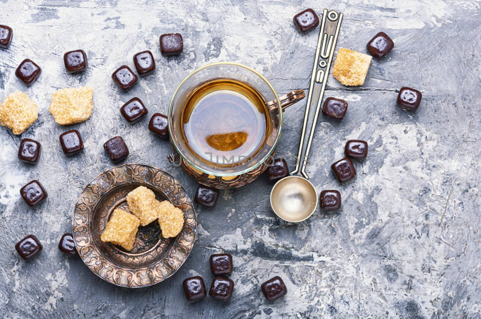 Eastern tea concept.Eastern tea in traditional glass with chocolate candy