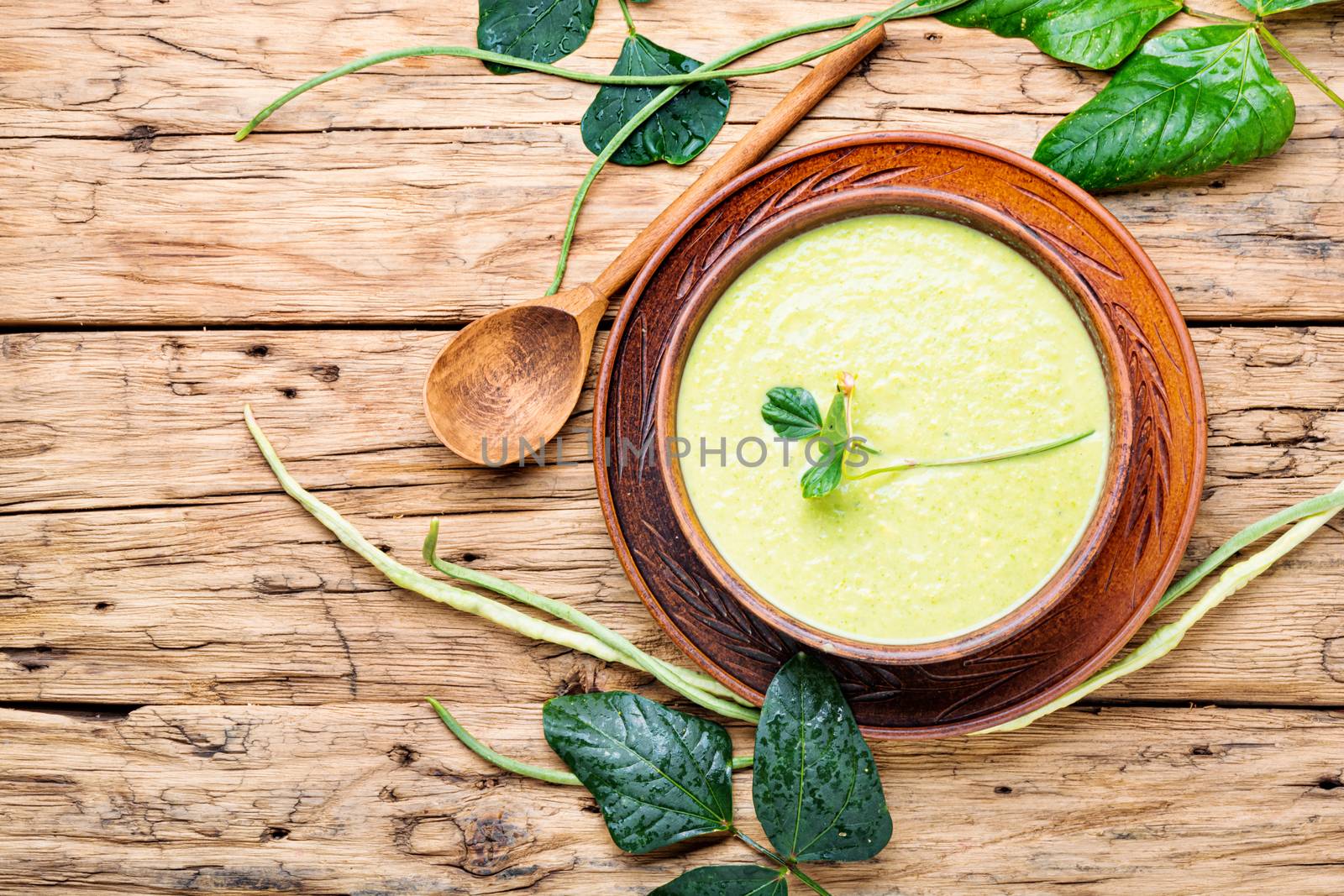 Fresh asparagus soup in bowl by LMykola