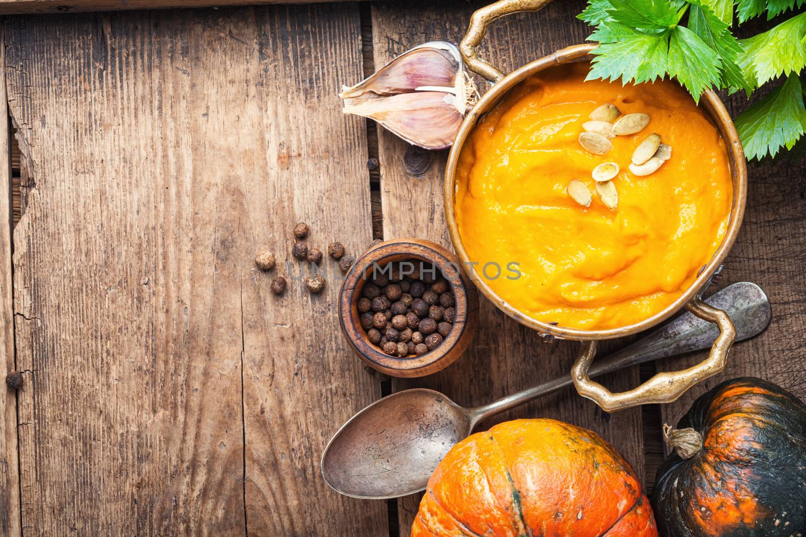 Pumpkin soup on rustic wooden background.Homemade pumpkin soup with spices
