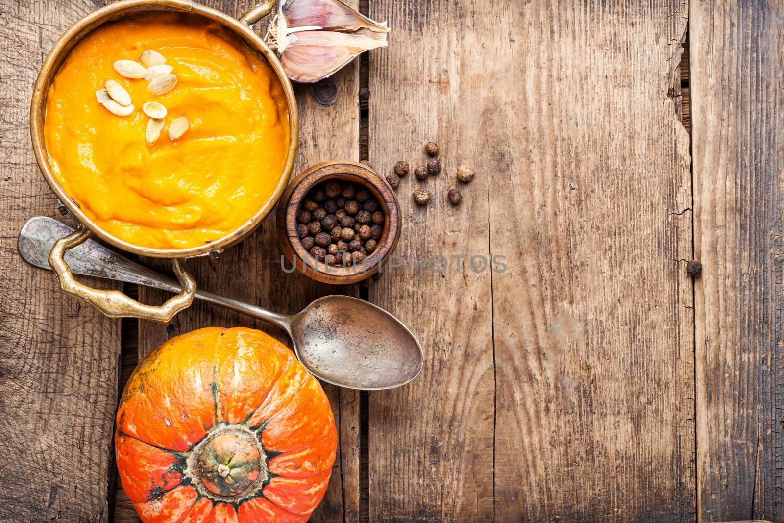 Pumpkin soup on a wooden table.Autumn pumpkin cream soup